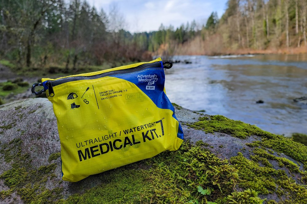 medical kit on rock by river