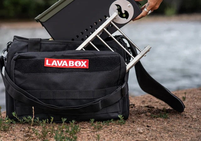 Close up of a lavaBox bag on the ground with lavabox firepit being put into it.