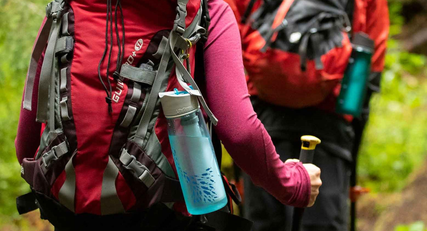 Lifestraw bottle attached to hiker's backpack