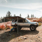 ROAM Adventure Co. Rooftop Awning provides shelter to someone enjoying the outdoors