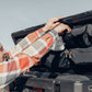 Man arranging gear and tools using the lid organizer in an 83L Rugged Case